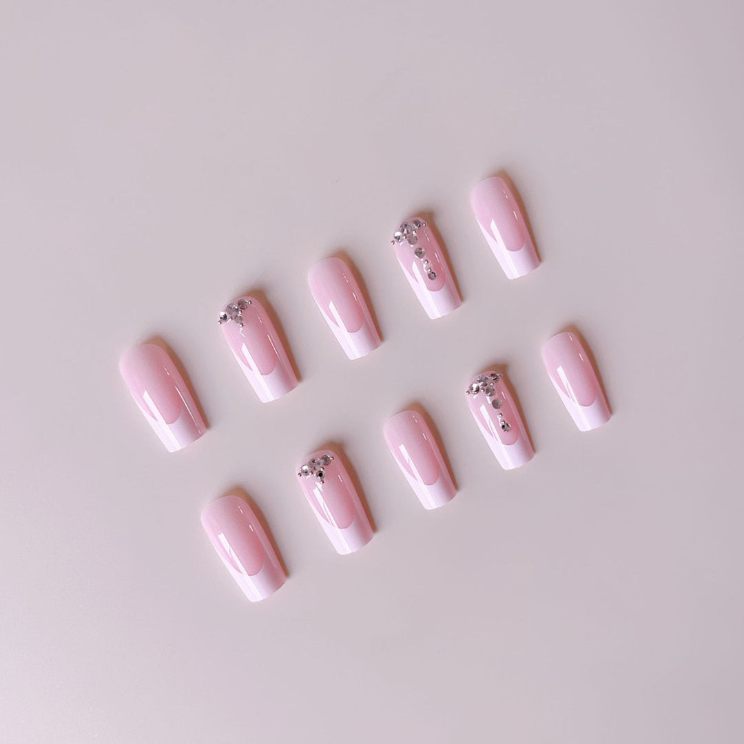 Acrylic nail set with elegant French tips and sparkling rhinestone accents Kalsten