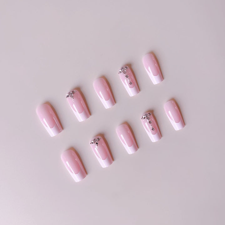 Acrylic nail set with elegant French tips and sparkling rhinestone accents Kalsten