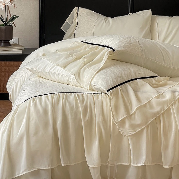 Luxurious bedding set with chiffon ruffles, comforter and contrast piping
