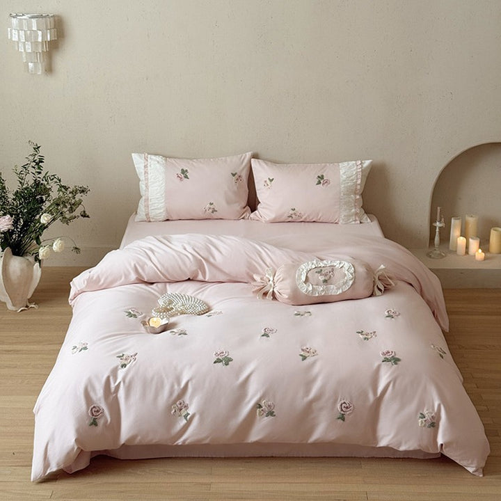 Luxurious cotton bedding set with delicate rose embroidery and ruffles