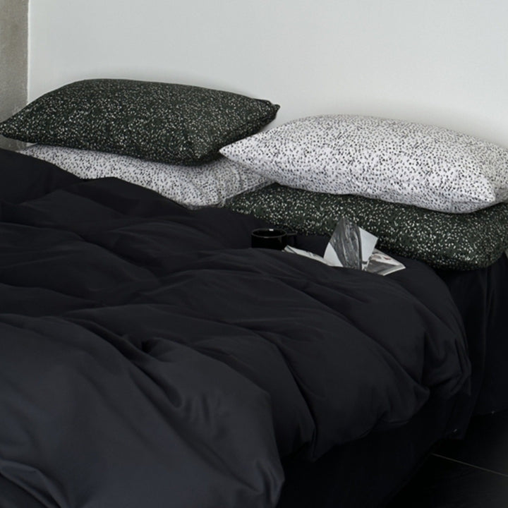 Modern satin bedding set with quilted look and patterned pillowcases