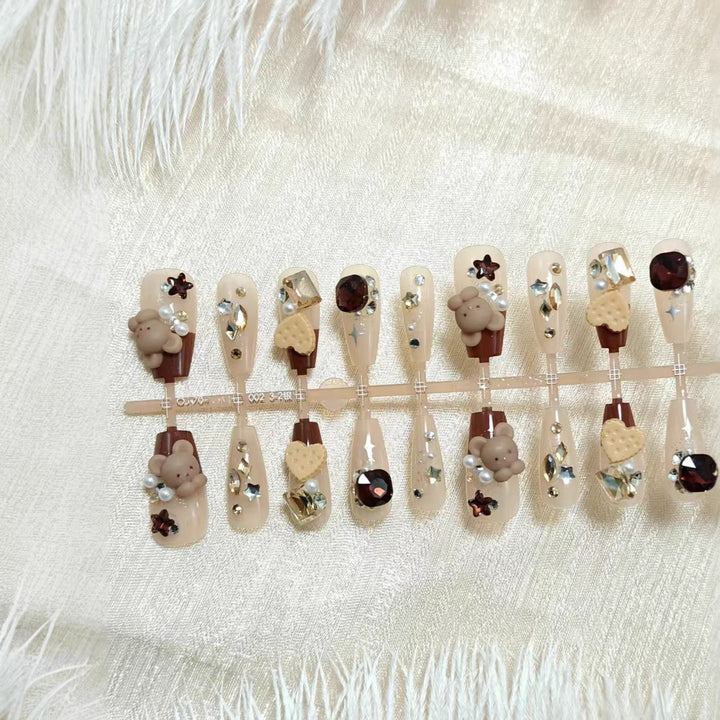 Creative acrylic nails with animal motifs and glitter accents Kalsten
