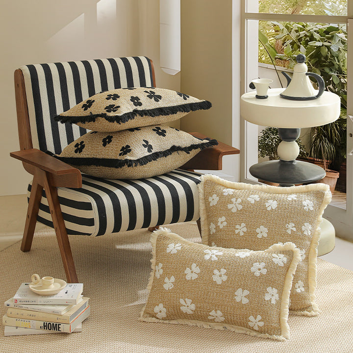 Rectangular woven decorative pillow with contrasting flower tufting and fringe trim