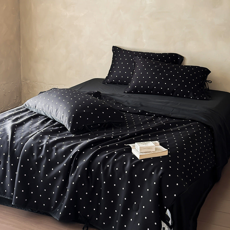 Satin bedding set with delicate polka dot pattern and satin finish