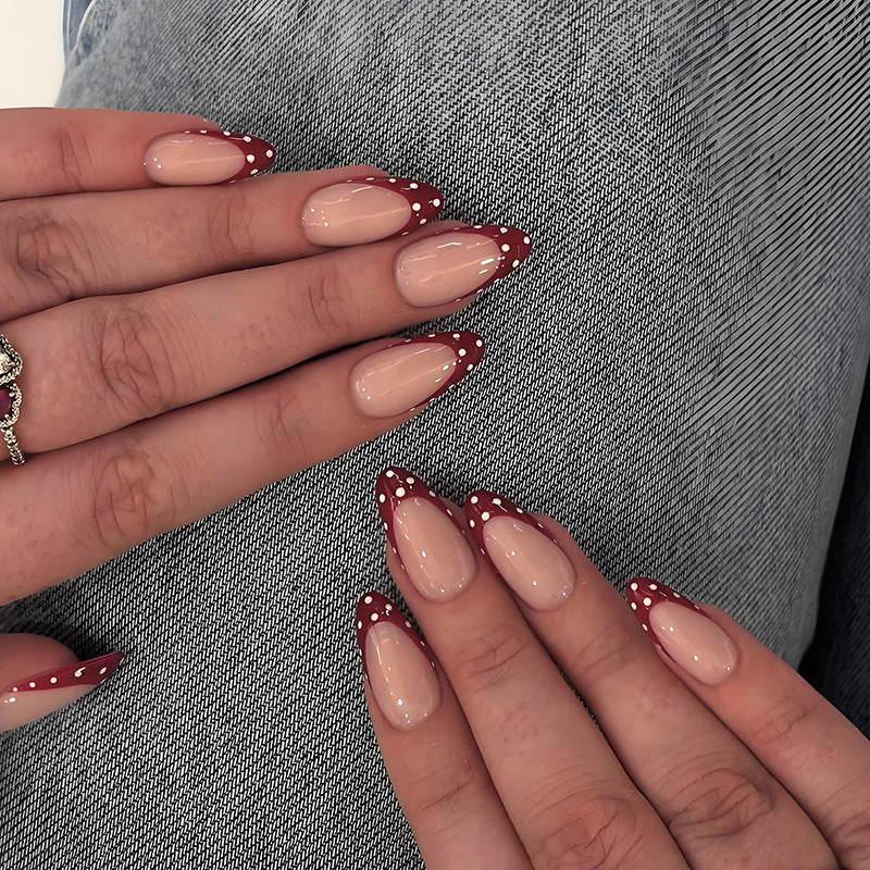 Nail art set with elegant red tips and playful dots Kalsten