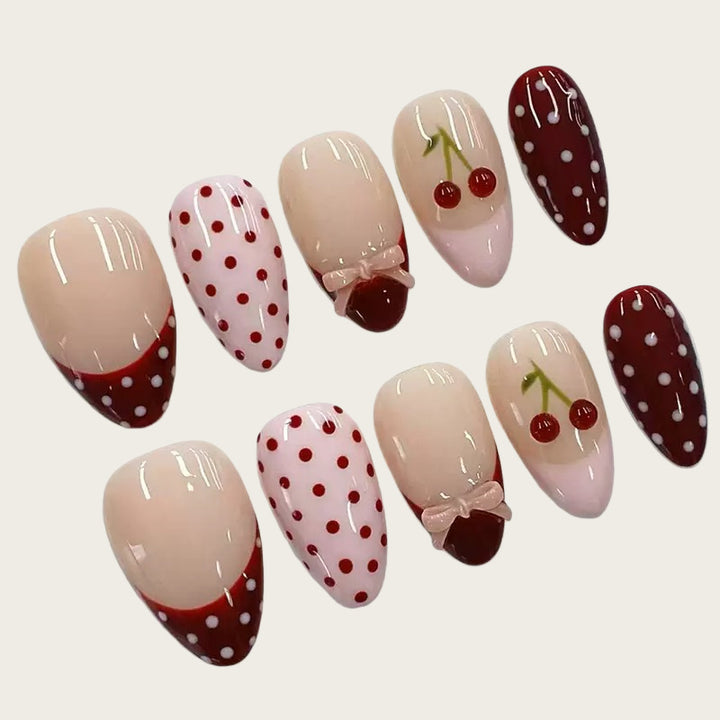 Artfully designed nail tips with cherry and dot motifs Kalsten