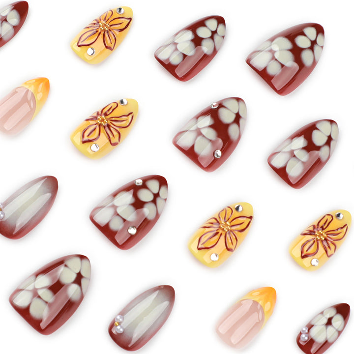 Artificial nail extensions with floral design and rhinestone embellishments Kalsten