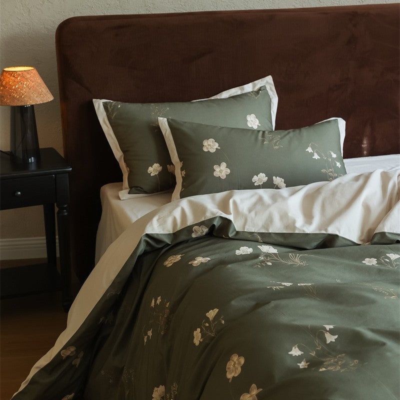 Cotton satin bedding set with subtle botanical print and contrasting hem edge