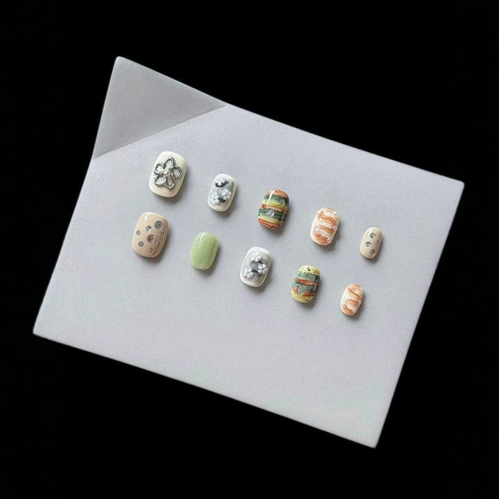 Artistic Press-On Nail Set with Floral and Textured Designs