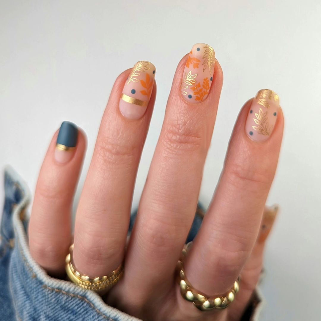 Artistic nail design with floral and golden accent Kalsten