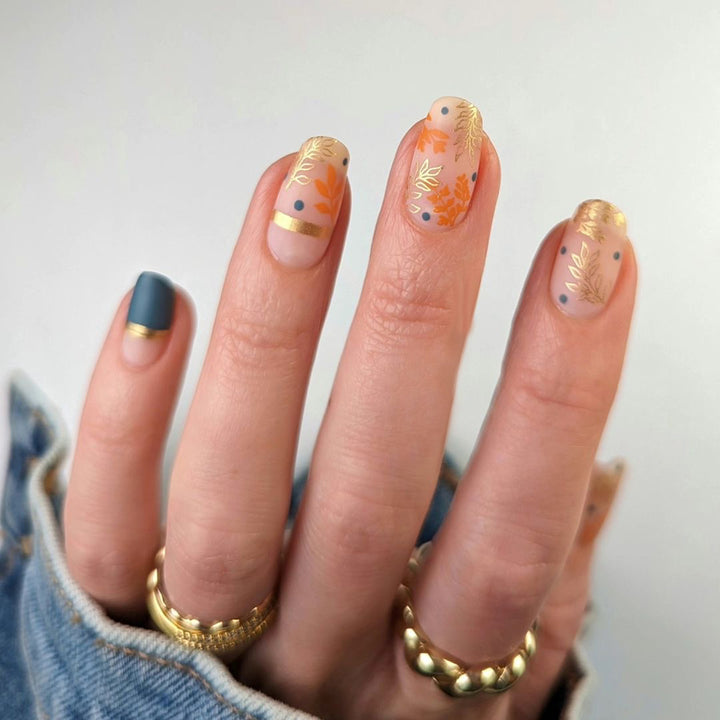 Artistic nail design with floral and golden accent Kalsten