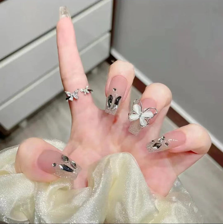 Artful Nail Art with Glitter and Butterfly Elements Kalsten