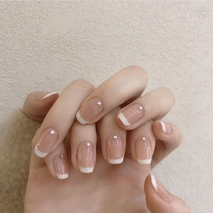 Artificial nails with elegant French tip and rhinestone accents Kalsten