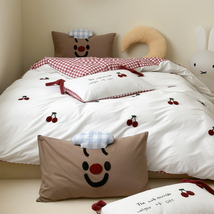 Children's bedding set with embroidered sprinkle appliqués, cuddle pillow and reversible function