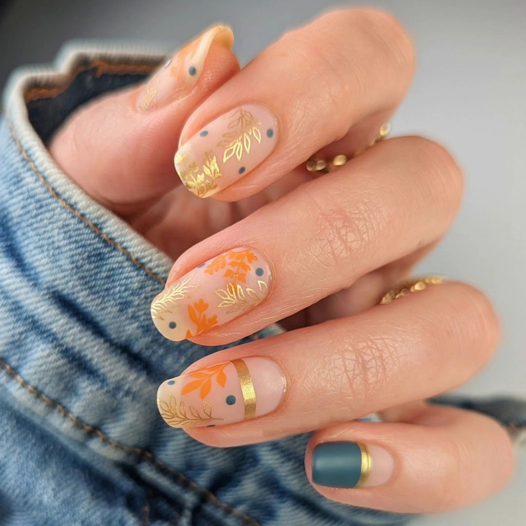 Artistic nail design with floral and golden accent Kalsten