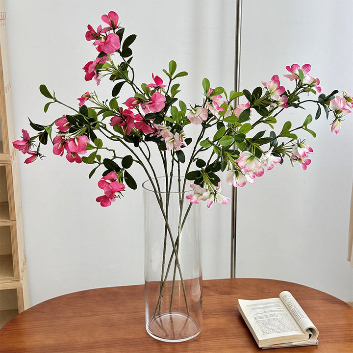 Artificial flower branch with vibrant pink flowers