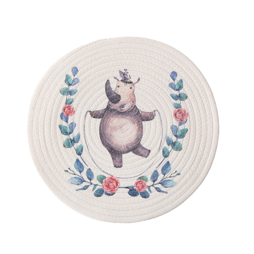 Round placemat made of woven cotton with a cute rhinoceros illustration and floral wreath Kalsten