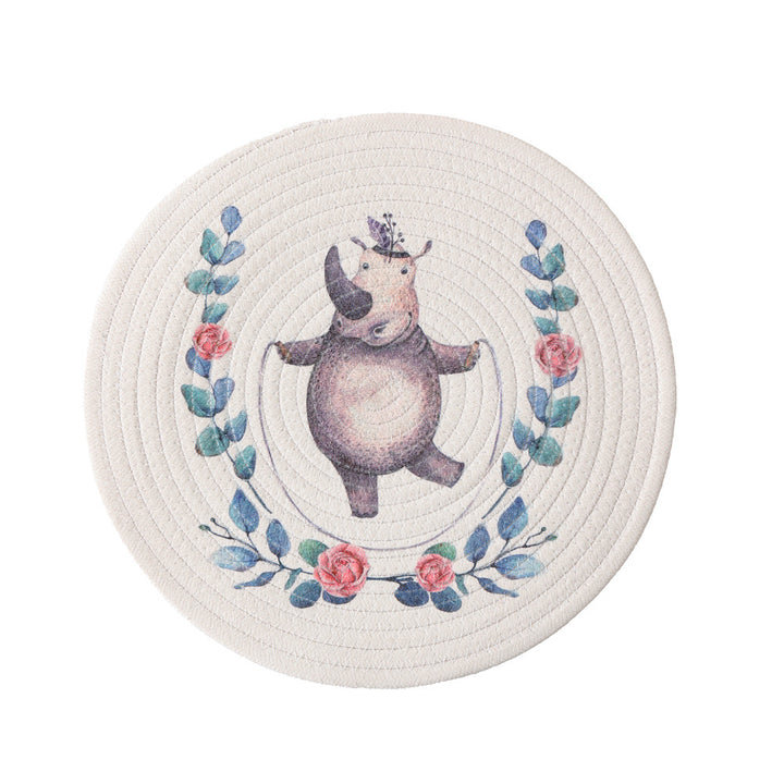 Round placemat made of woven cotton with a cute rhinoceros illustration and floral wreath Kalsten