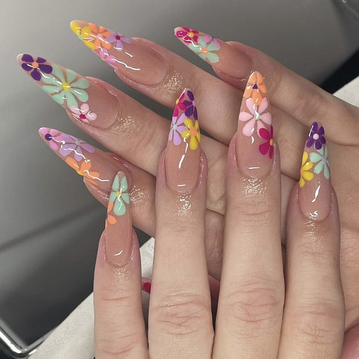 Acrylic nail set with vibrant floral designs and sharp accents Kalsten