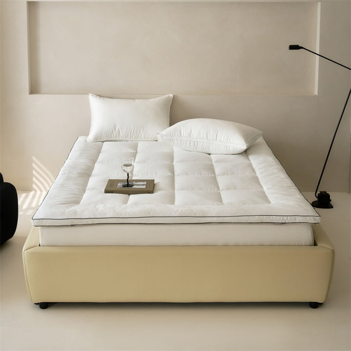 Padded mattress topper made of quilted microfiber and cotton comfort