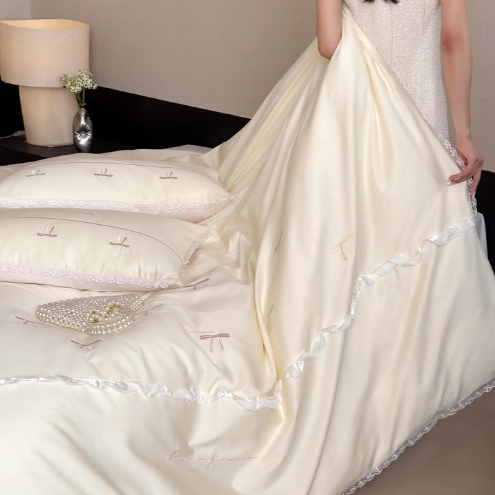 Elegant bedding set made of silky fine satin with embroidered bows and lace trim