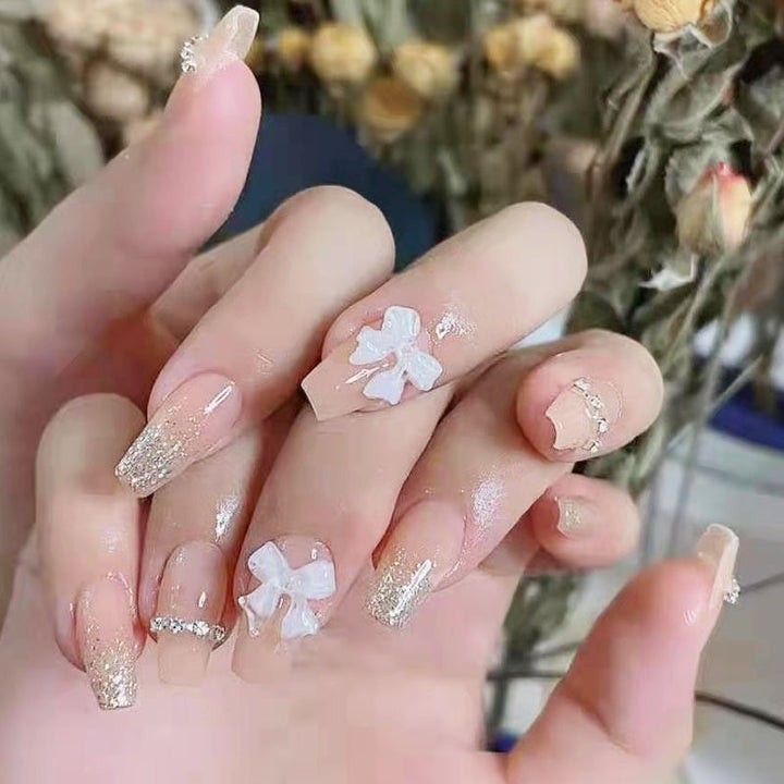 Artificial nails with elegant bow accents and pearl decorations Kalsten