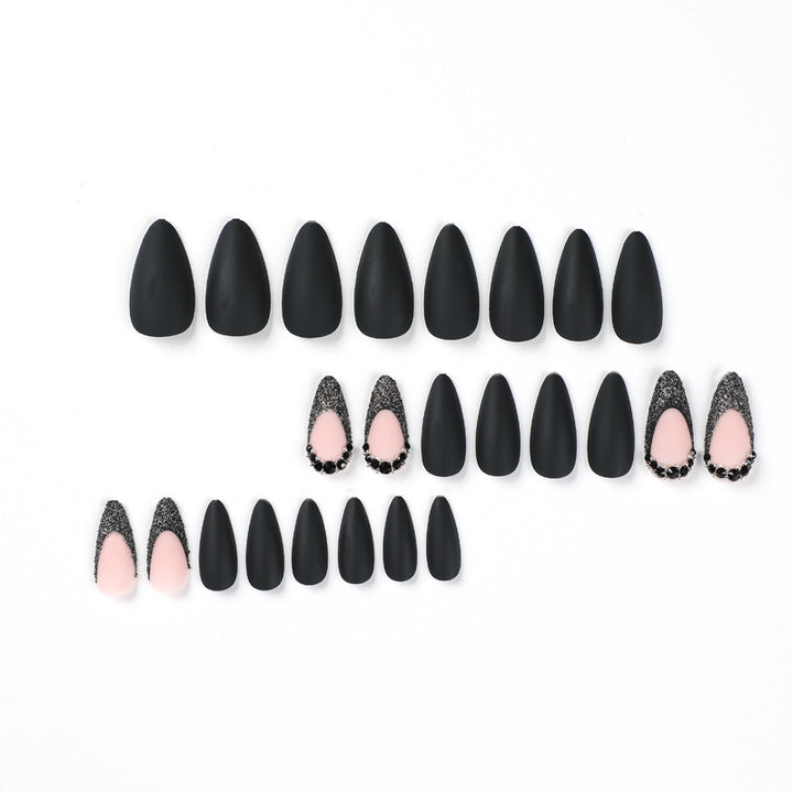 Artful stiletto nails with elegant black design and glitter accents Kalsten