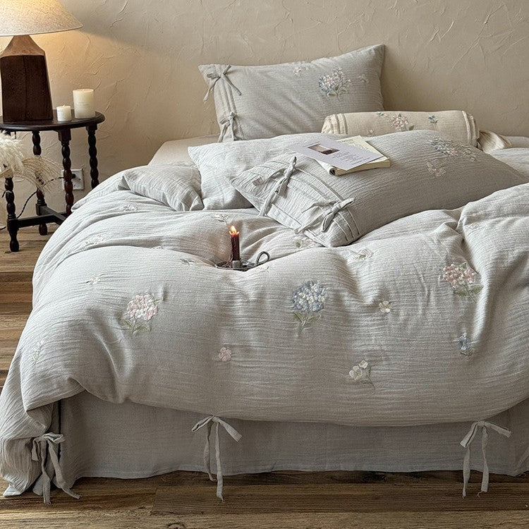 Embroidered cotton-linen bedding set with decorative ribbons and fine floral design