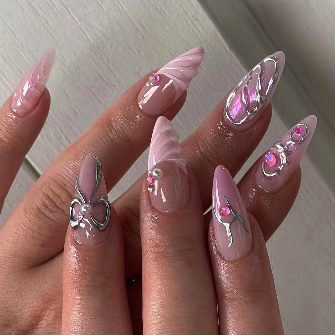Artful stiletto nails with glitter and pearl decorations Kalsten