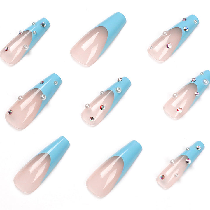 Artificial nail extensions with glitter and pearl accents Kalsten