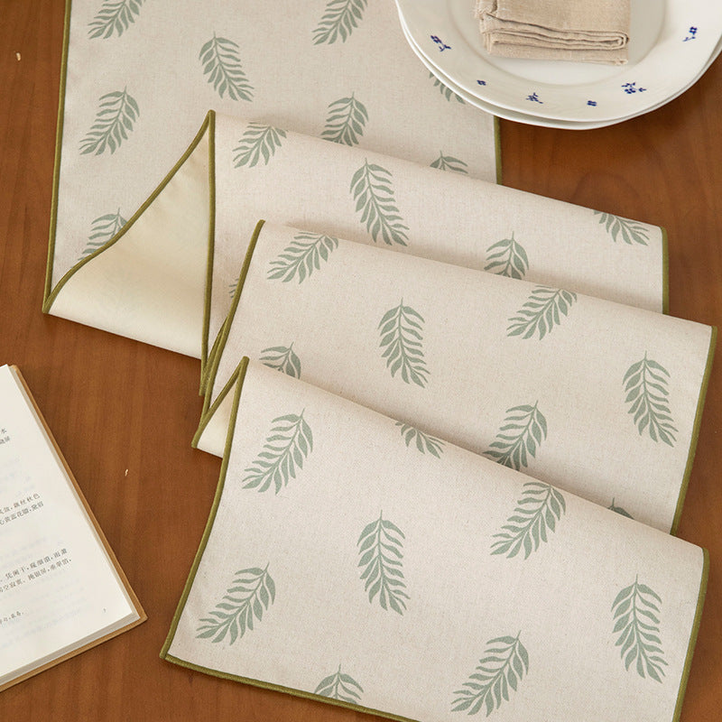 Woven table runner in botanical leaf pattern made of cotton blend Kalsten