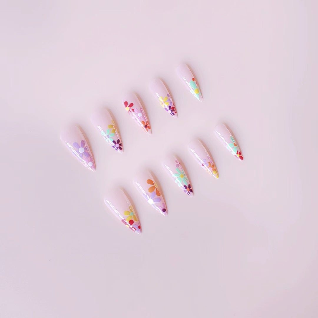 Acrylic nail set with vibrant floral designs and sharp accents Kalsten