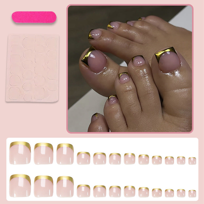 Toenail art set with elegant gold tips and delicate embellishments Kalsten