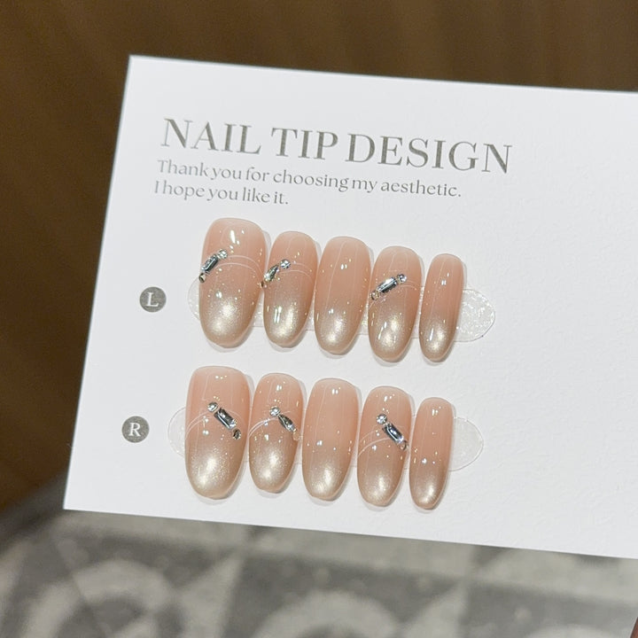 Artificial nail tips with elegant gradient color and rhinestone accents Kalsten