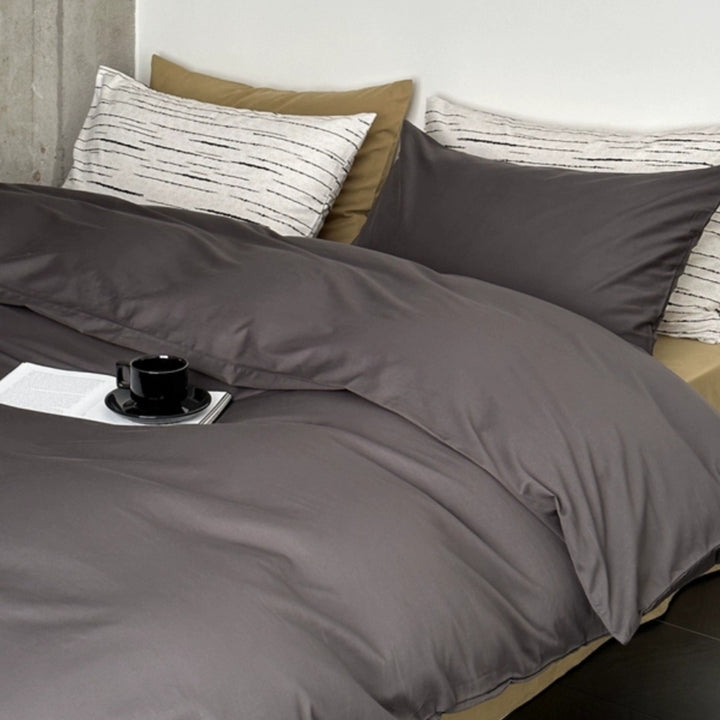 Modern satin bedding set with quilted look and patterned pillowcases