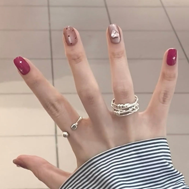 Artificial nail extensions with unique jewelry accents Kalsten
