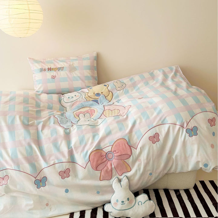 Playful cotton bedding set with embroidered bunny and cherry motif including decorative pillow