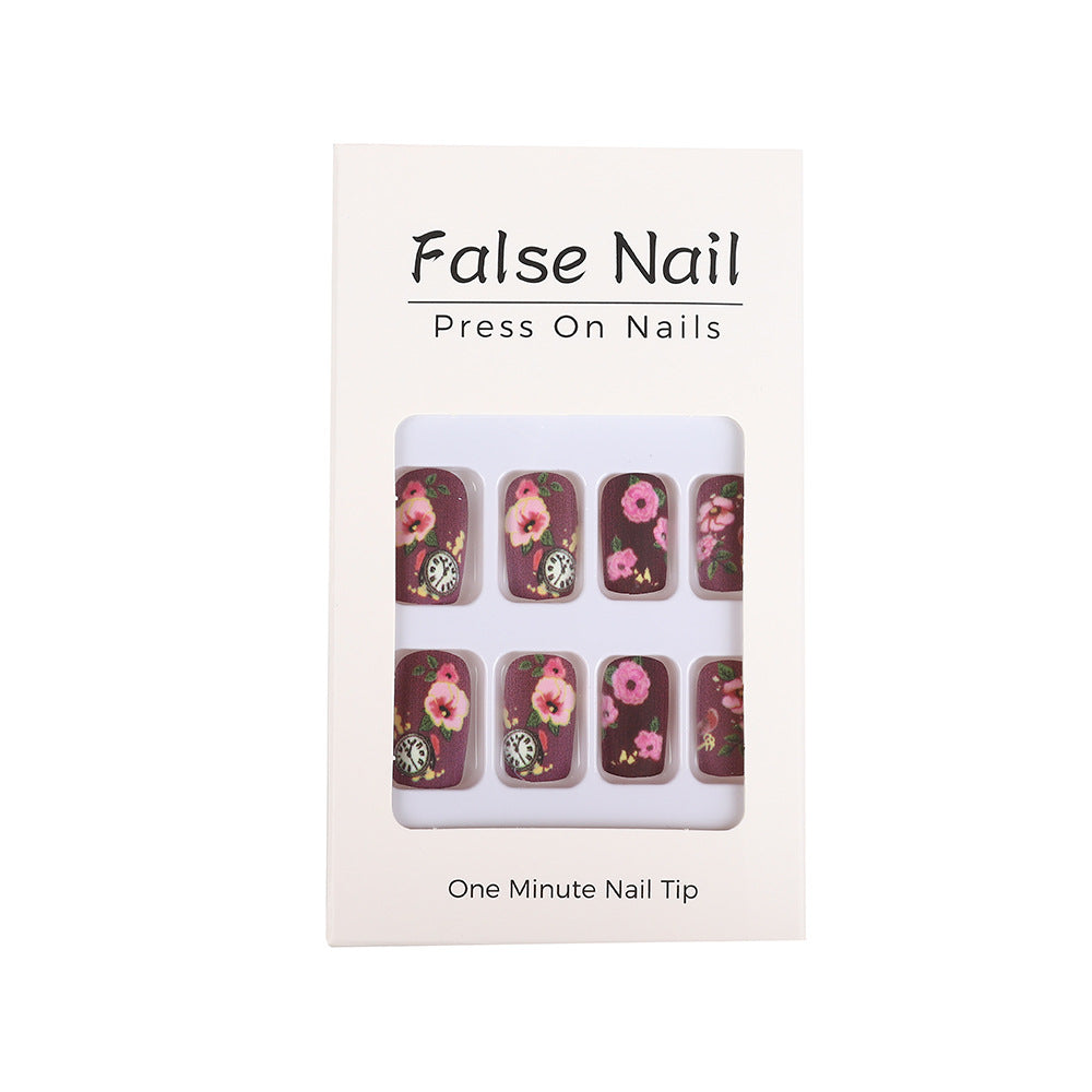 Nail art with floral design and intricate clock motifs Kalsten