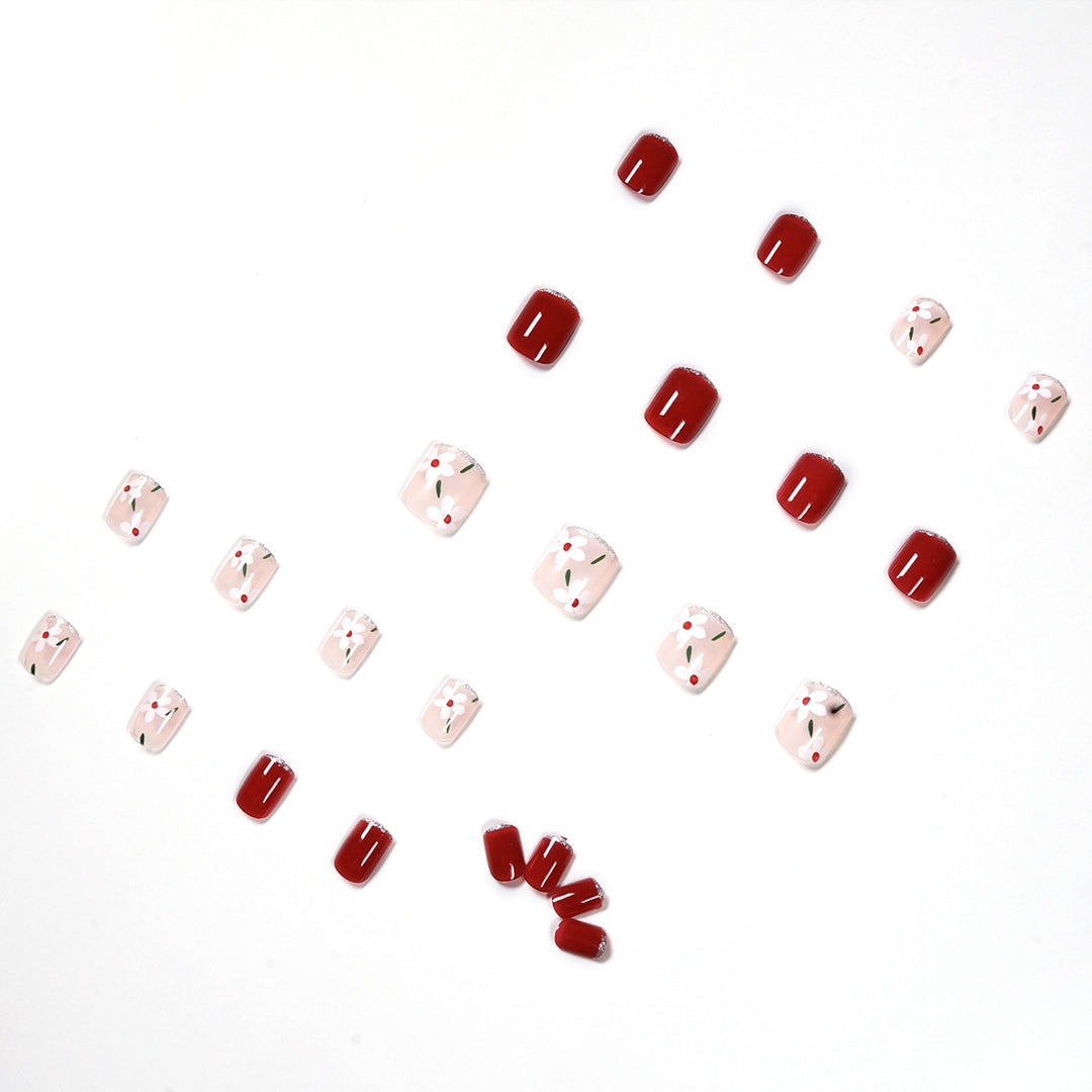 Artful nail art with floral motifs and glitter accents Kalsten