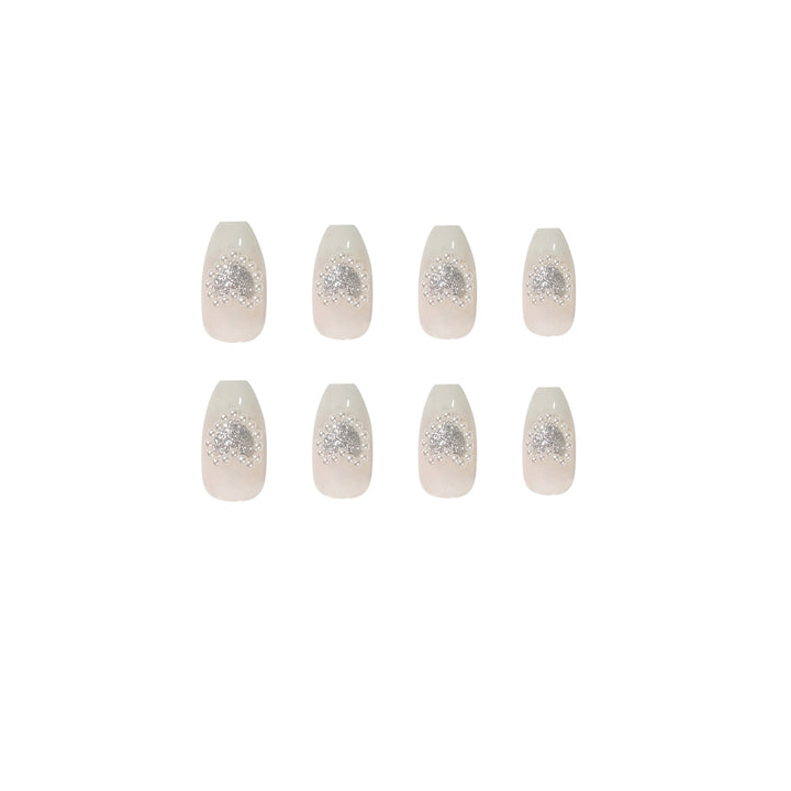 Artificial nail art with heart and rhinestone decorations Kalsten