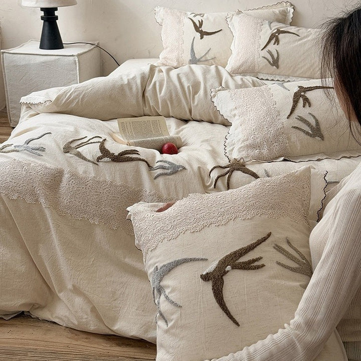High-quality bedding set with embroidered swallows, lace trim and linen look