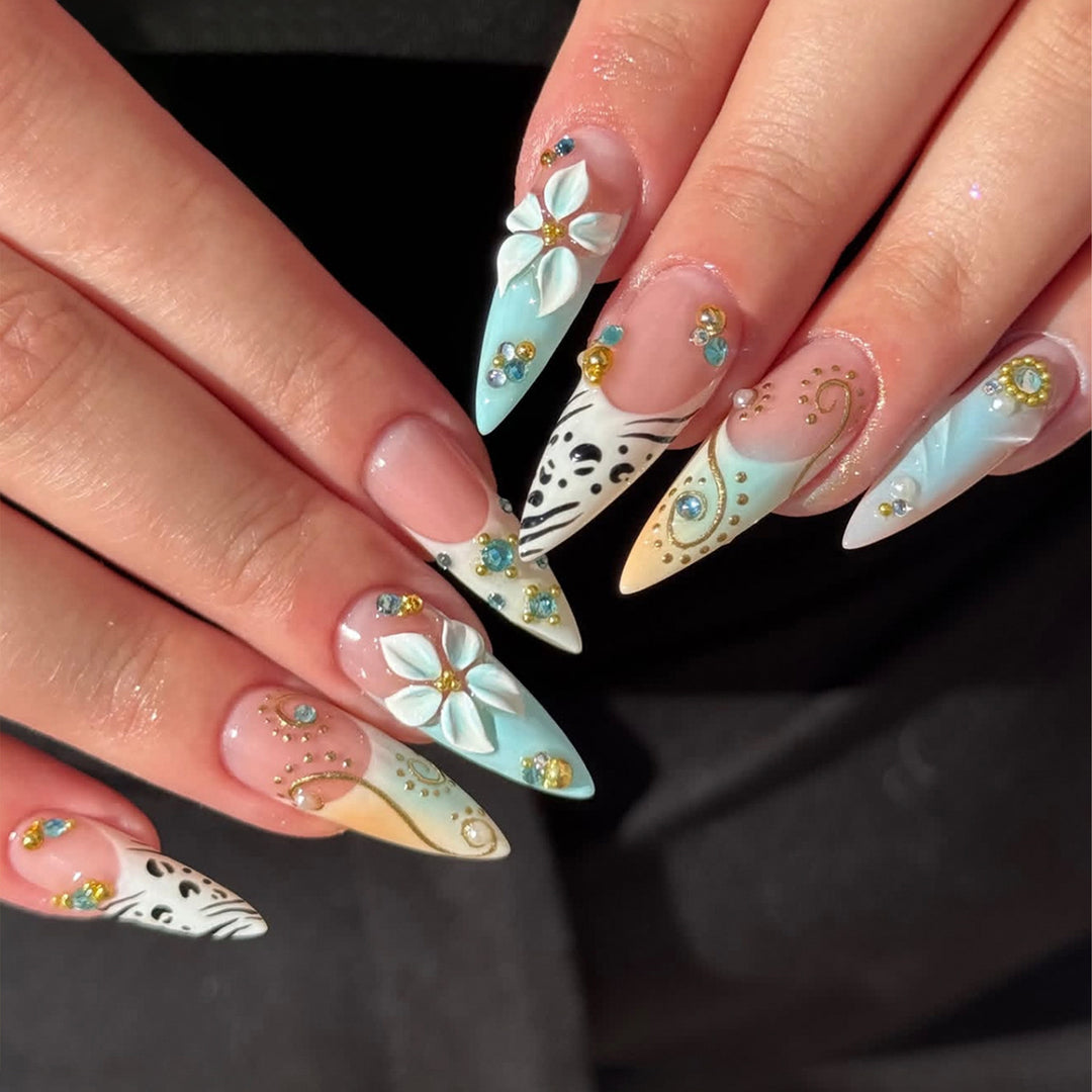 Artistic stiletto nails with floral accents and glitter details Kalsten