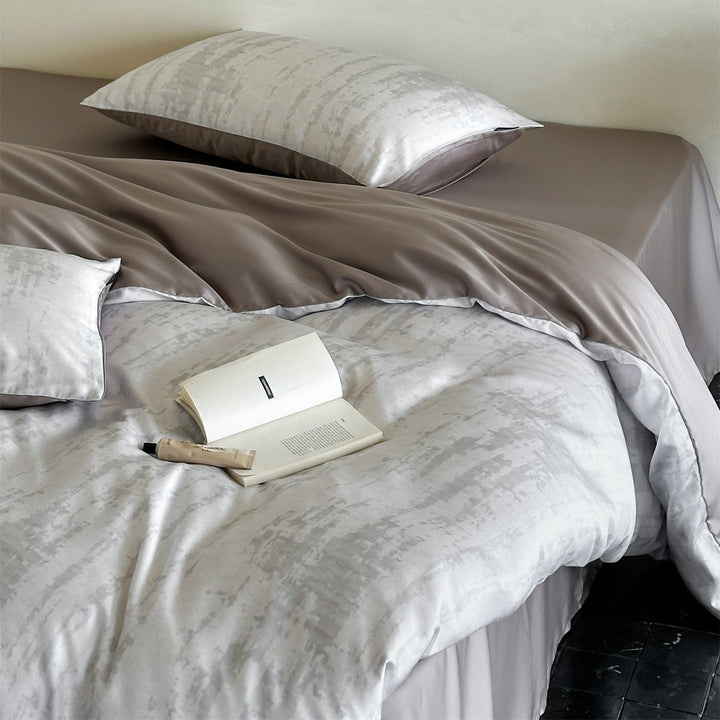 Luxurious satin bedding set with floral watercolor print, ruffled edges and reversible function