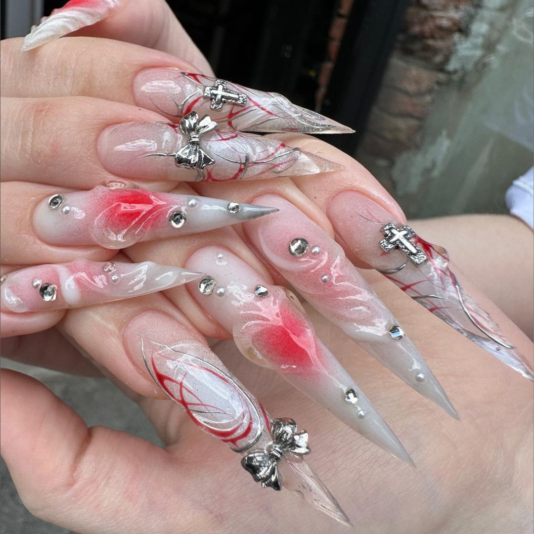 Artful stiletto nails with elegant floral accents and glitter embellishments Kalsten