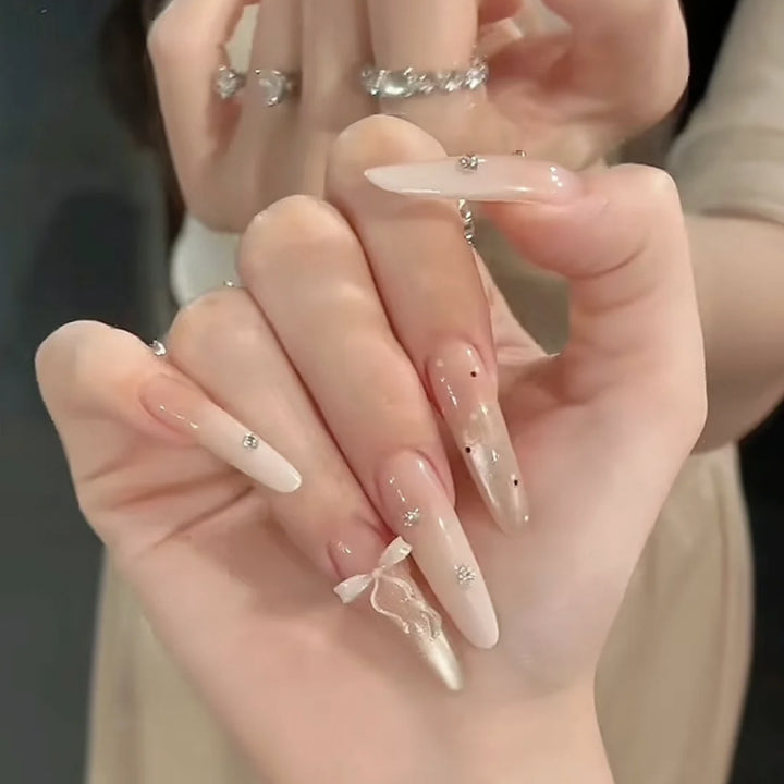 Artificial nails with elegant ombre design and delicate accents Kalsten
