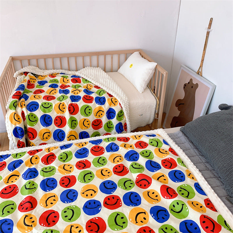 Children's quilt with colorful dinosaur print and soft minky border