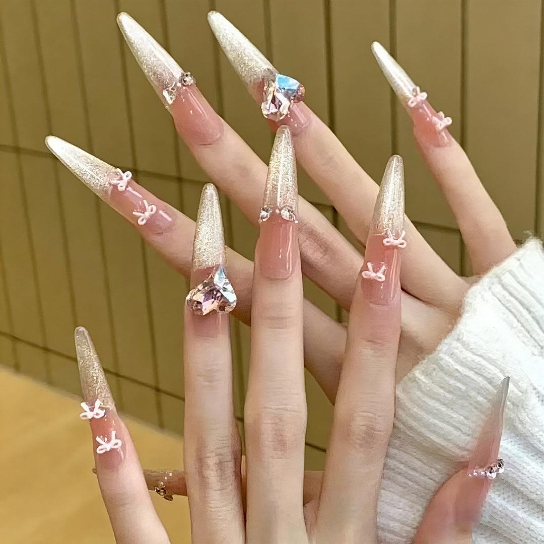 Art nail set with sparkling tips and delicate bow decorations Kalsten