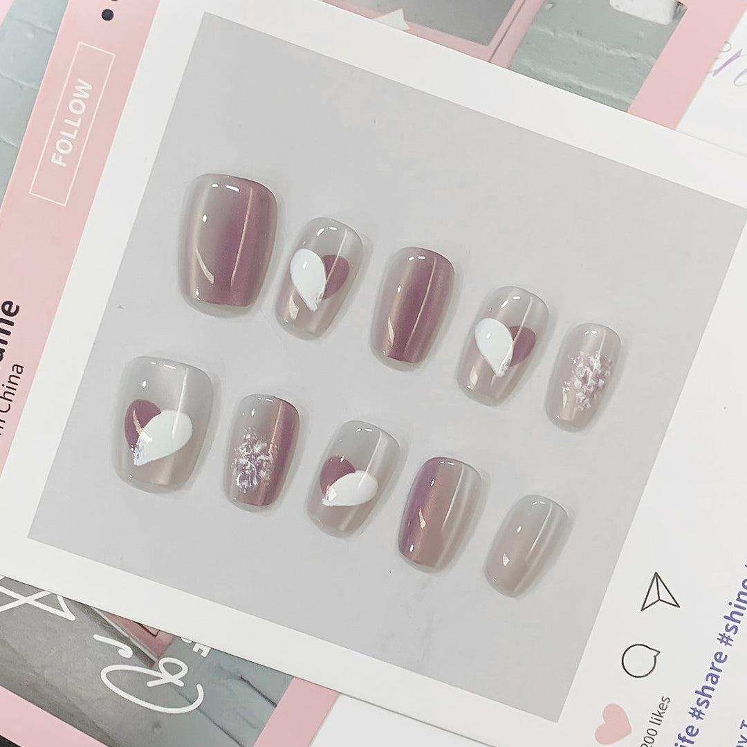Artistic acrylic nails with heart-shaped accents Kalsten