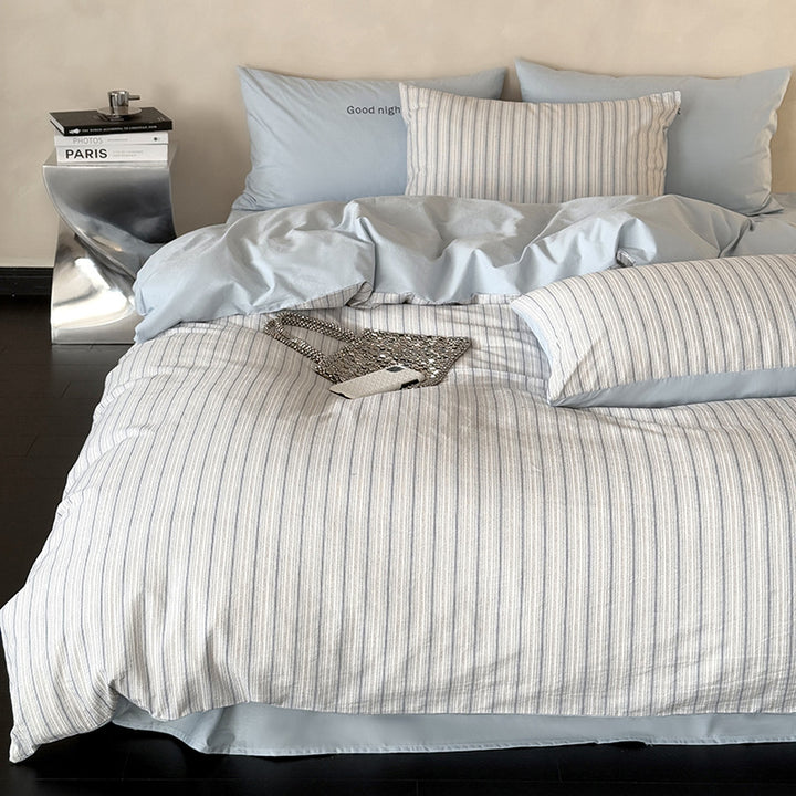 Modern bedding set made of breathable cotton muslin with a fine stripe pattern and reversible function
