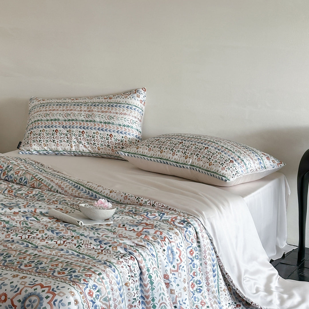 Satin bed linen set with ruffled bed skirt and floral printed pillowcases